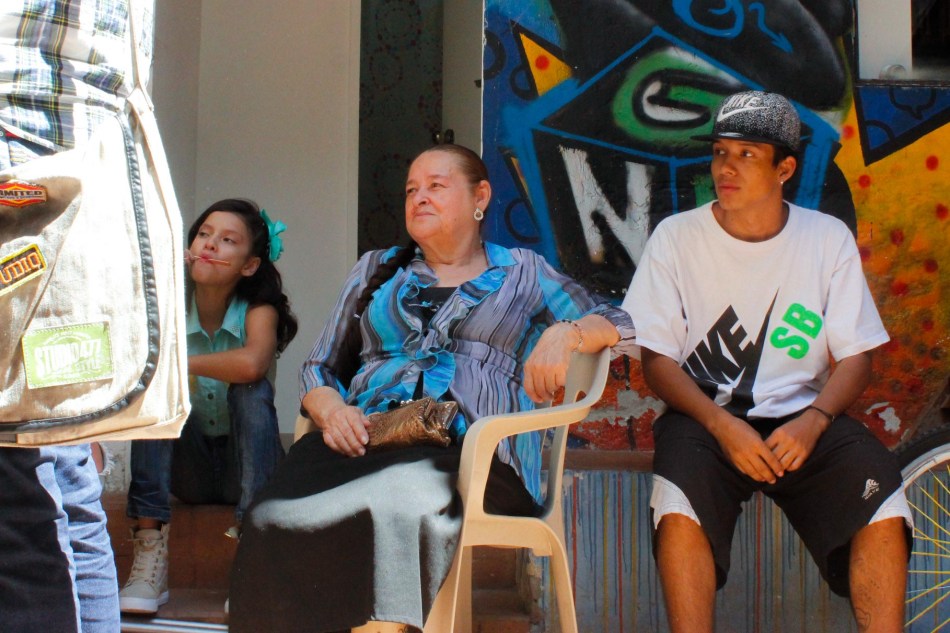 Abuela Rapera looks on at young rappers in Casa Morada.jpg